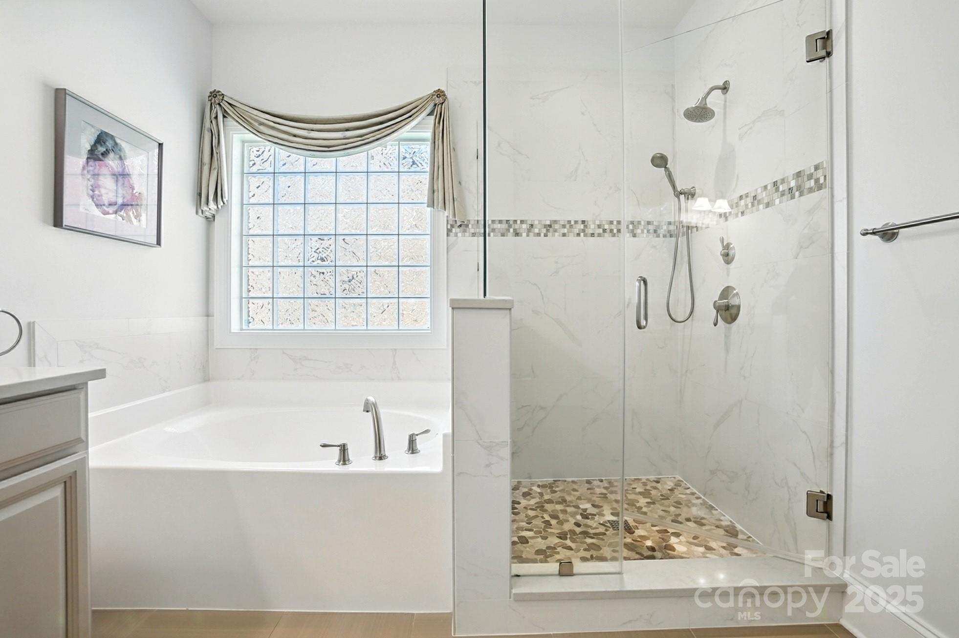 10906 Round Rock Road Charlotte, NC 28277 - Photo 21 of 45 a bathroom with a bathtub and shower