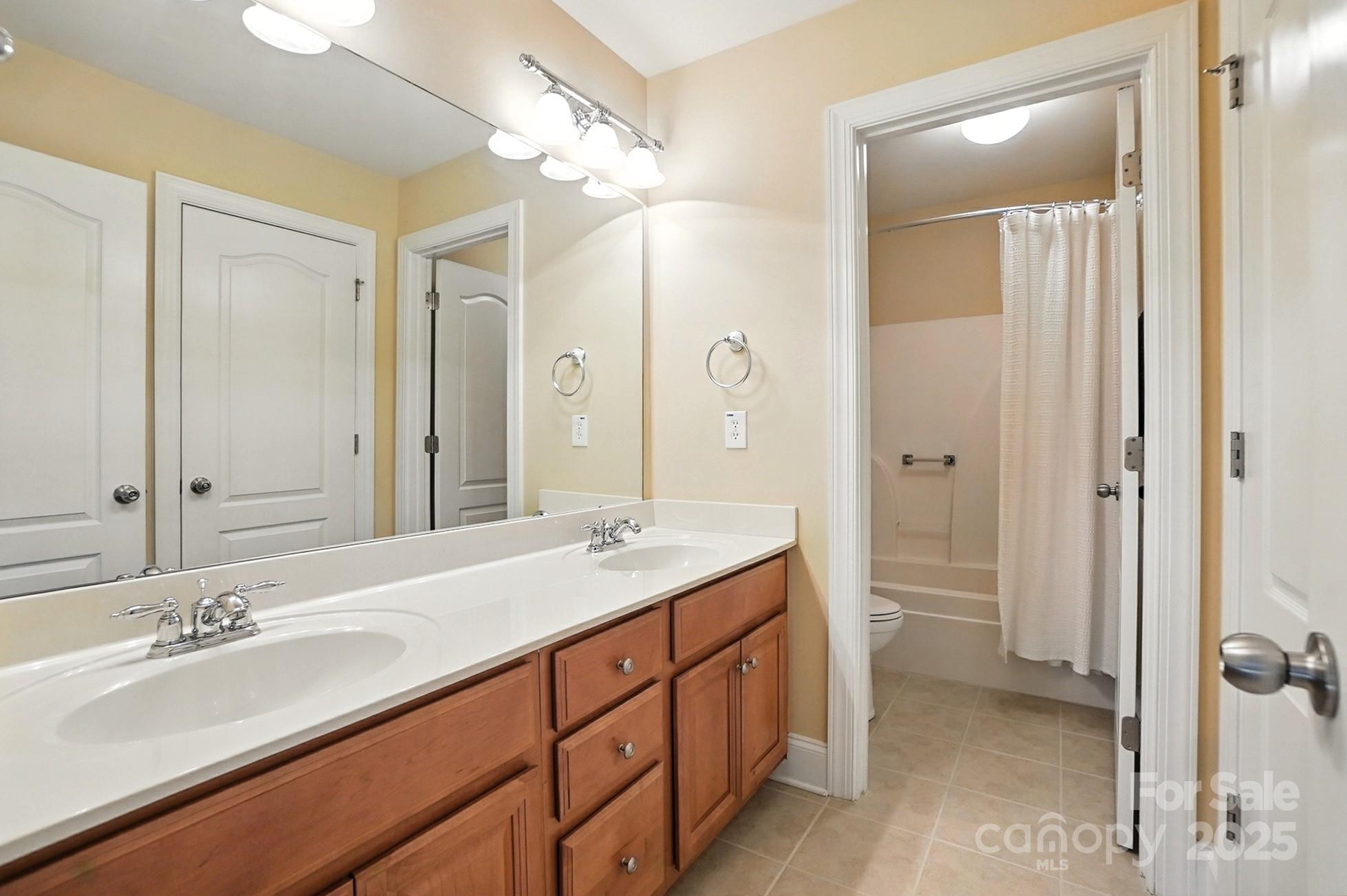 10906 Round Rock Road Charlotte, NC 28277 - Photo 33 of 45 a bathroom with a double vanity sink mirror and double