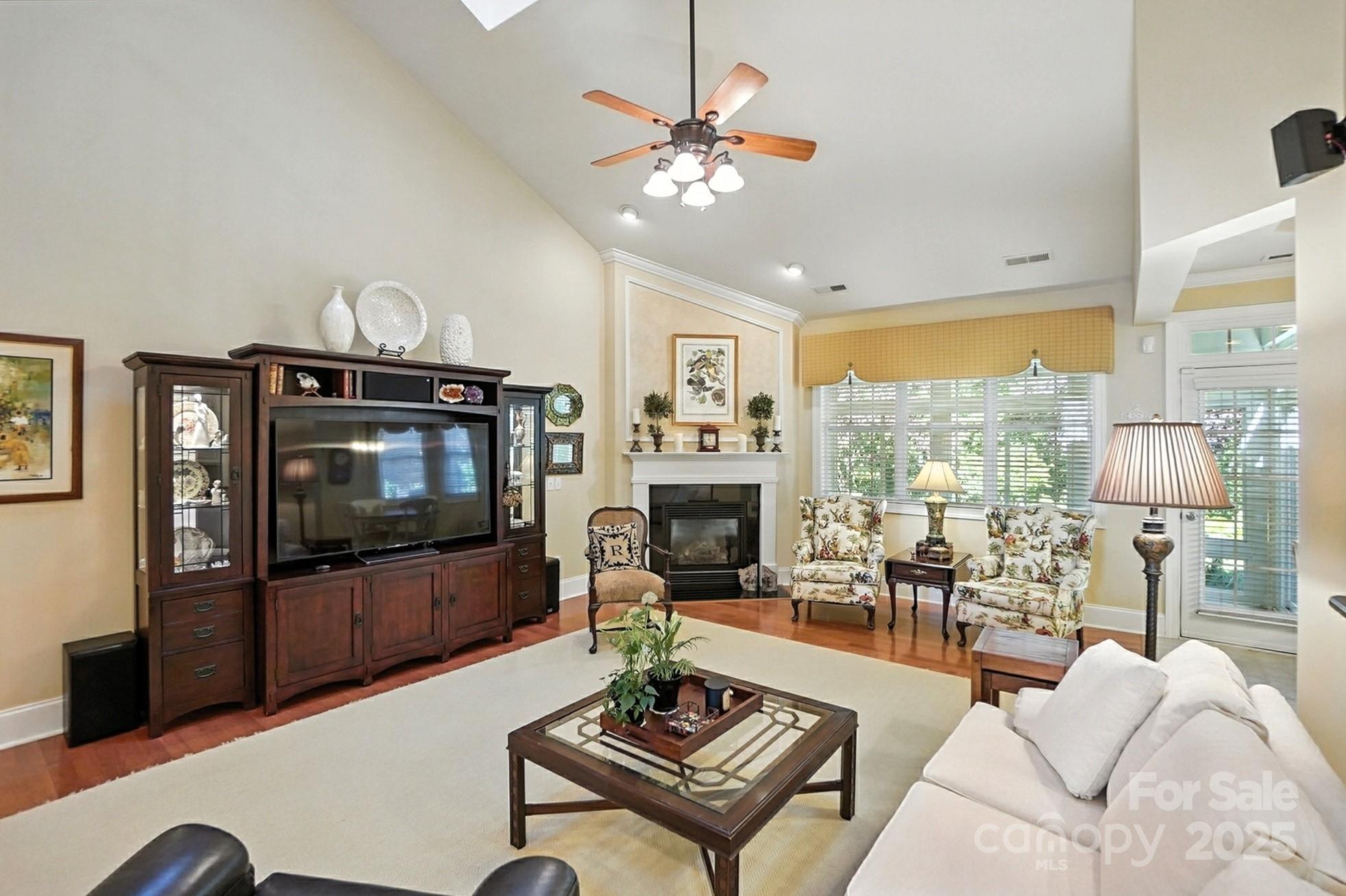 10906 Round Rock Road Charlotte, NC 28277 - Photo 7 of 45 a living room with furniture a flat screen tv and a large window