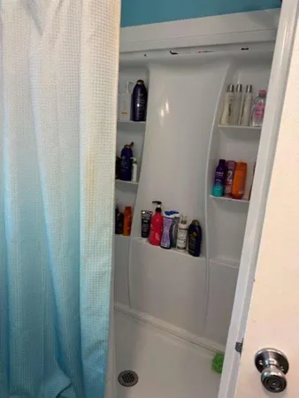a bathroom with a shower and a window