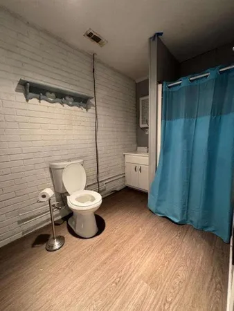 a bathroom with a toilet a sink and mirror