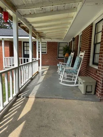 a view of a patio with table and chairs and wooden floor
