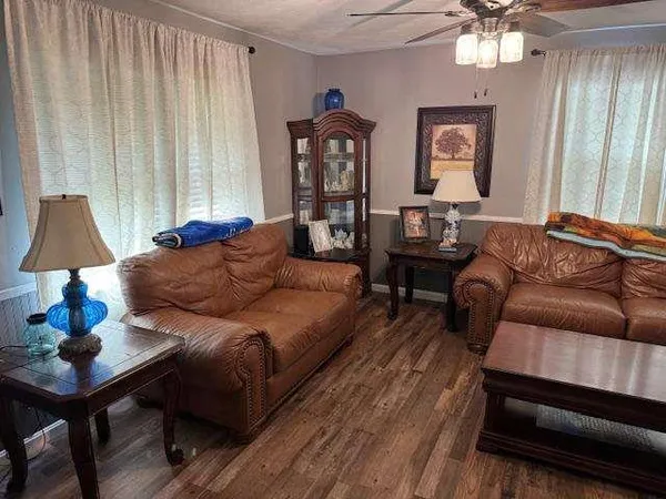 a living room with furniture a lamp and a window
