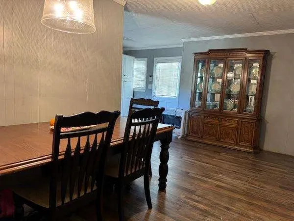 a dining room with furniture and wooden floor