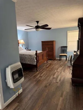 a bedroom with furniture and a wooden floor