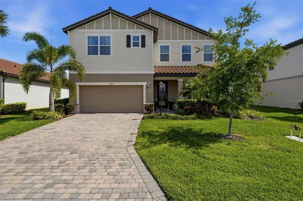 a front view of a house with a yard and garage