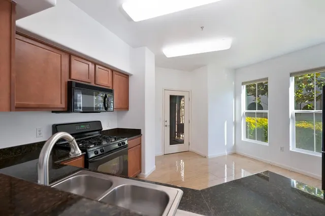 a view of an empty room with a ceiling fan