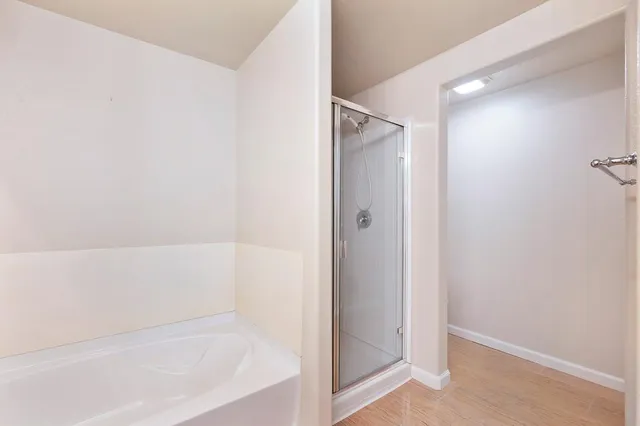 a kitchen with granite countertop cabinets and wooden floor