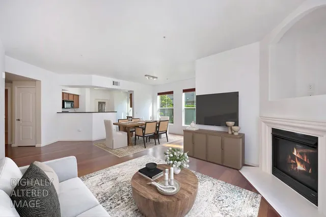 a view of a big room with wooden floor and windows