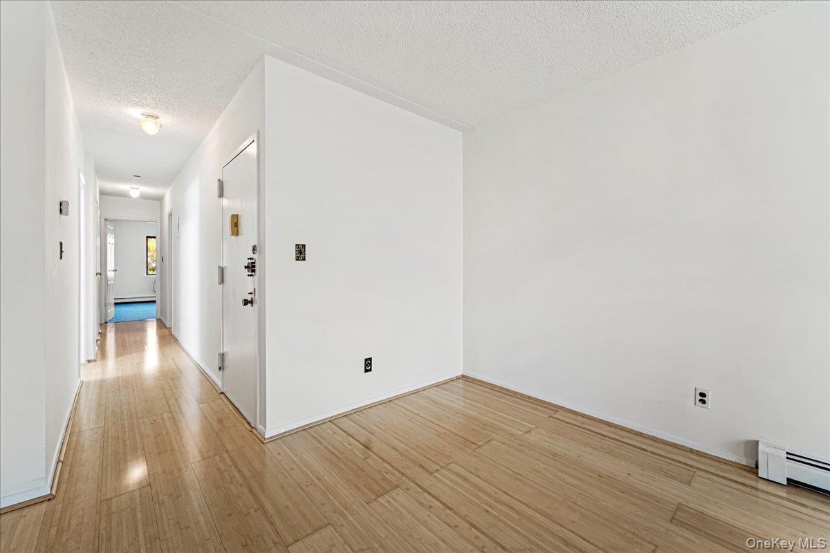 71-29 Sutton Place, Unit 3 Queens, NY 11365 - Photo 12 of 24 a view of a hallway with wooden floor