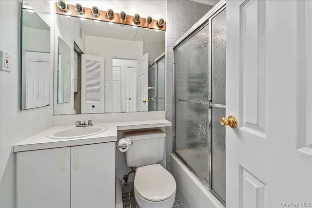 a bathroom with a toilet sink and shower
