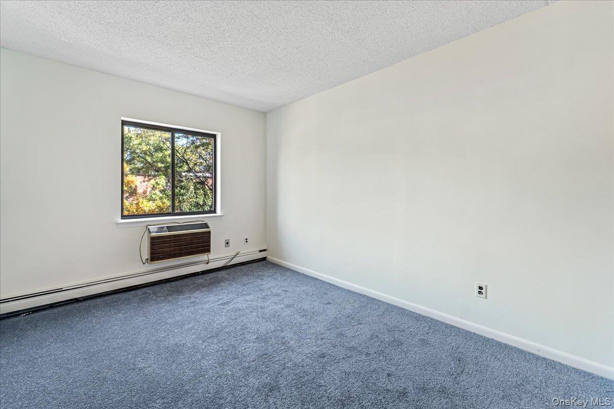 71-29 Sutton Place, Unit 3 Queens, NY 11365 - Photo 21 of 24 an empty room with windows