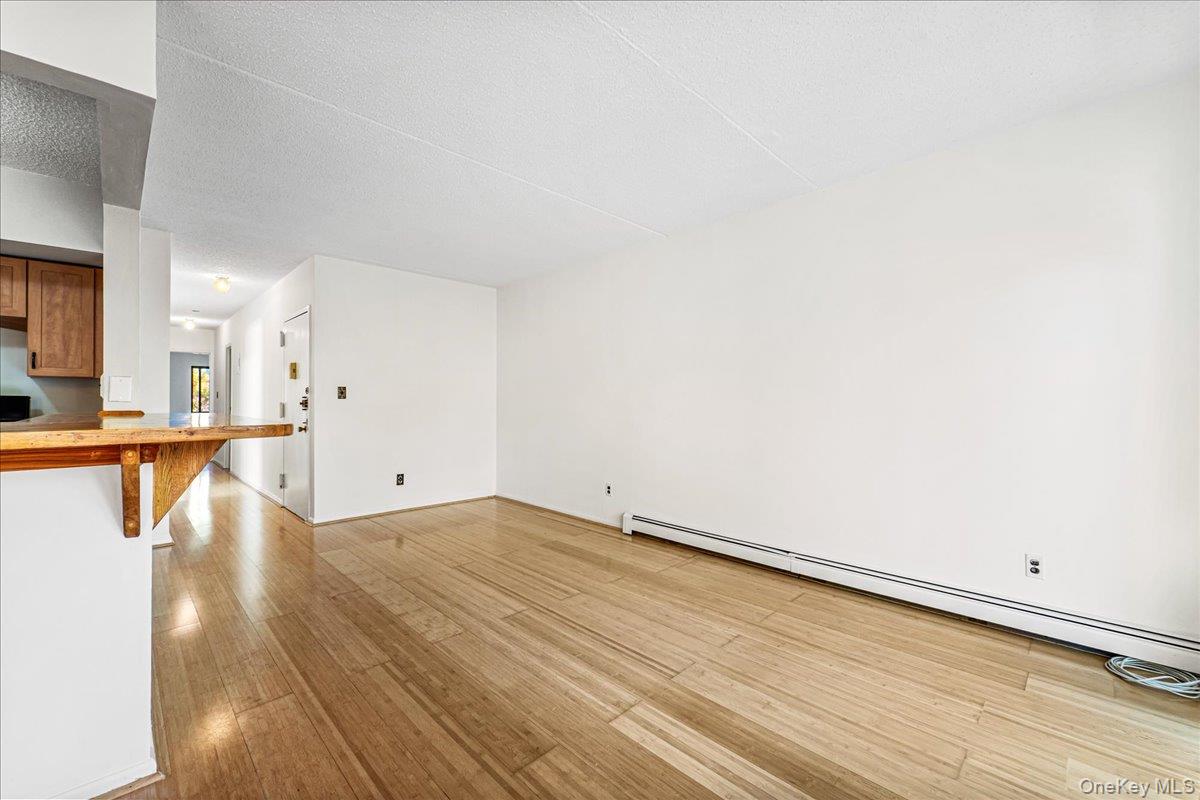71-29 Sutton Place, Unit 3 Queens, NY 11365 - Photo 4 of 24 a view of a room with wooden floor