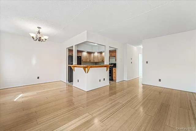 a view of a kitchen with a sink and wooden floor