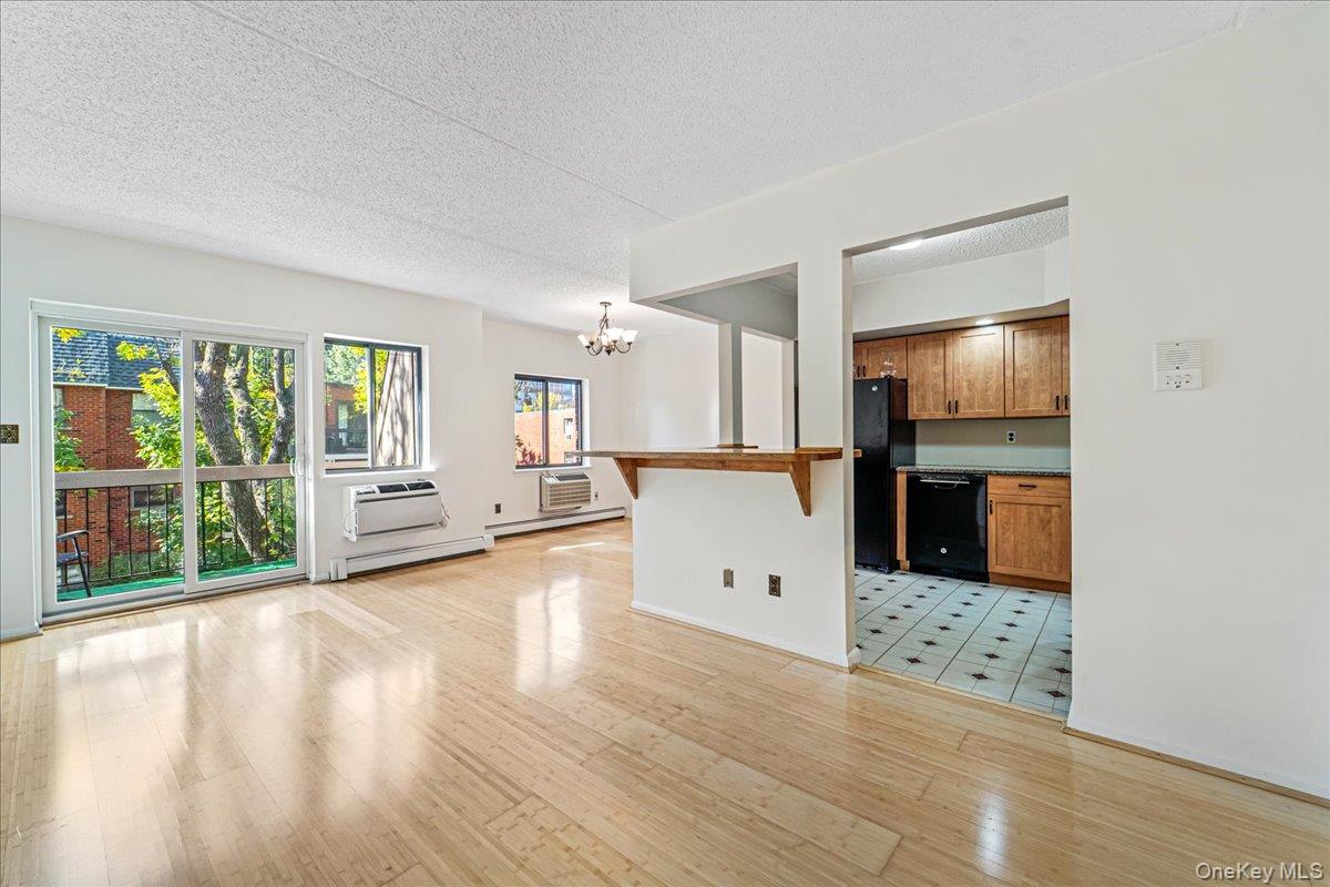 71-29 Sutton Place, Unit 3 Queens, NY 11365 - Photo 6 of 24 a view of a living room hardwood floor and a kitchen