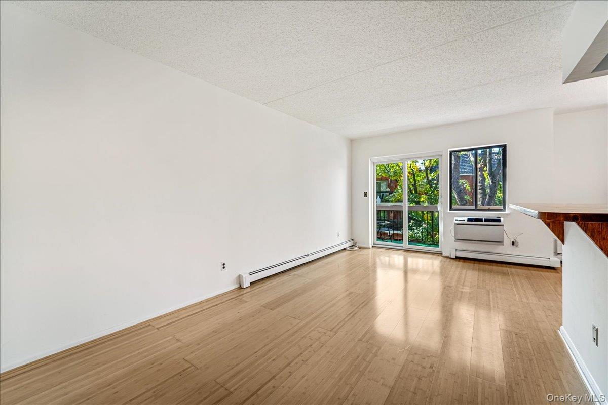 71-29 Sutton Place, Unit 3 Queens, NY 11365 - Photo 7 of 24 a view of a room with wooden floor and window