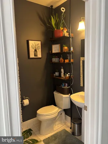 a bathroom with a toilet a sink and a mirror