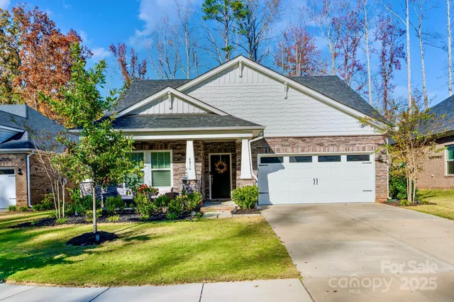 a front view of a house with a yard garage and outdoor seating