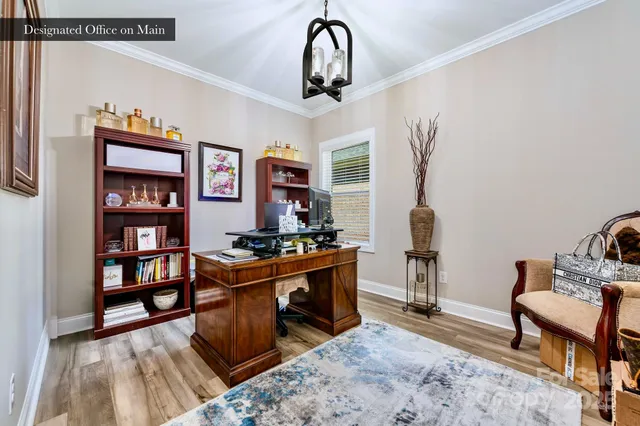 a view of a workspace with furniture and window