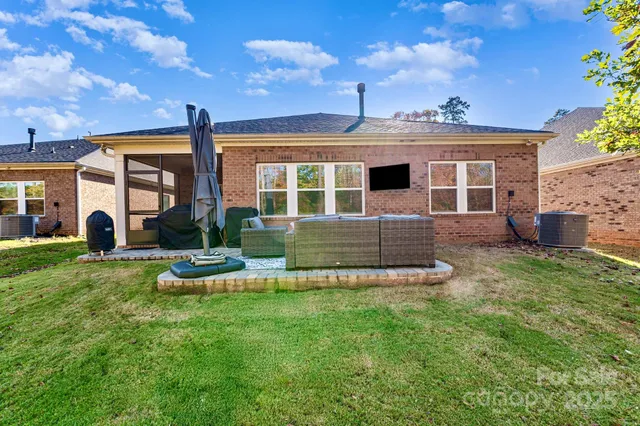 a view of a house with backyard and sitting area