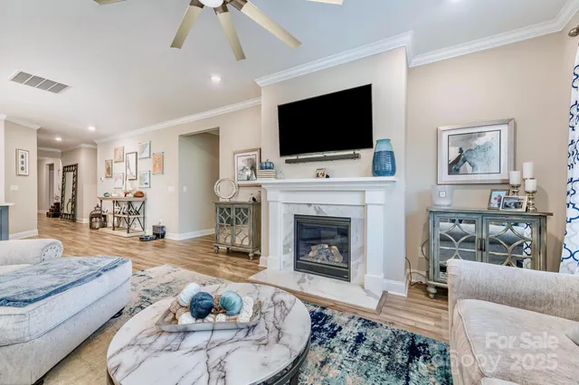 a living room with furniture a flat screen tv and a fireplace