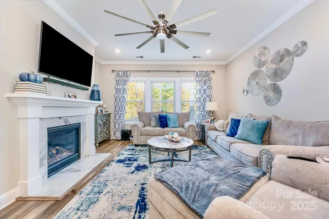 a living room with furniture a fireplace and a flat screen tv