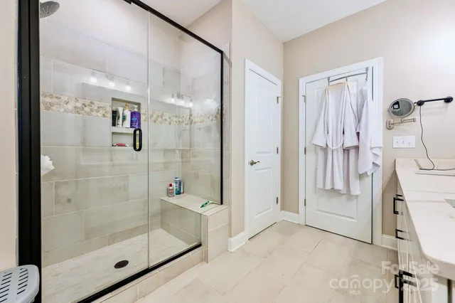 a bathroom with a shower and a sink