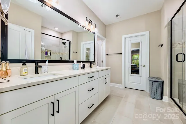a bathroom with double sink and a mirror