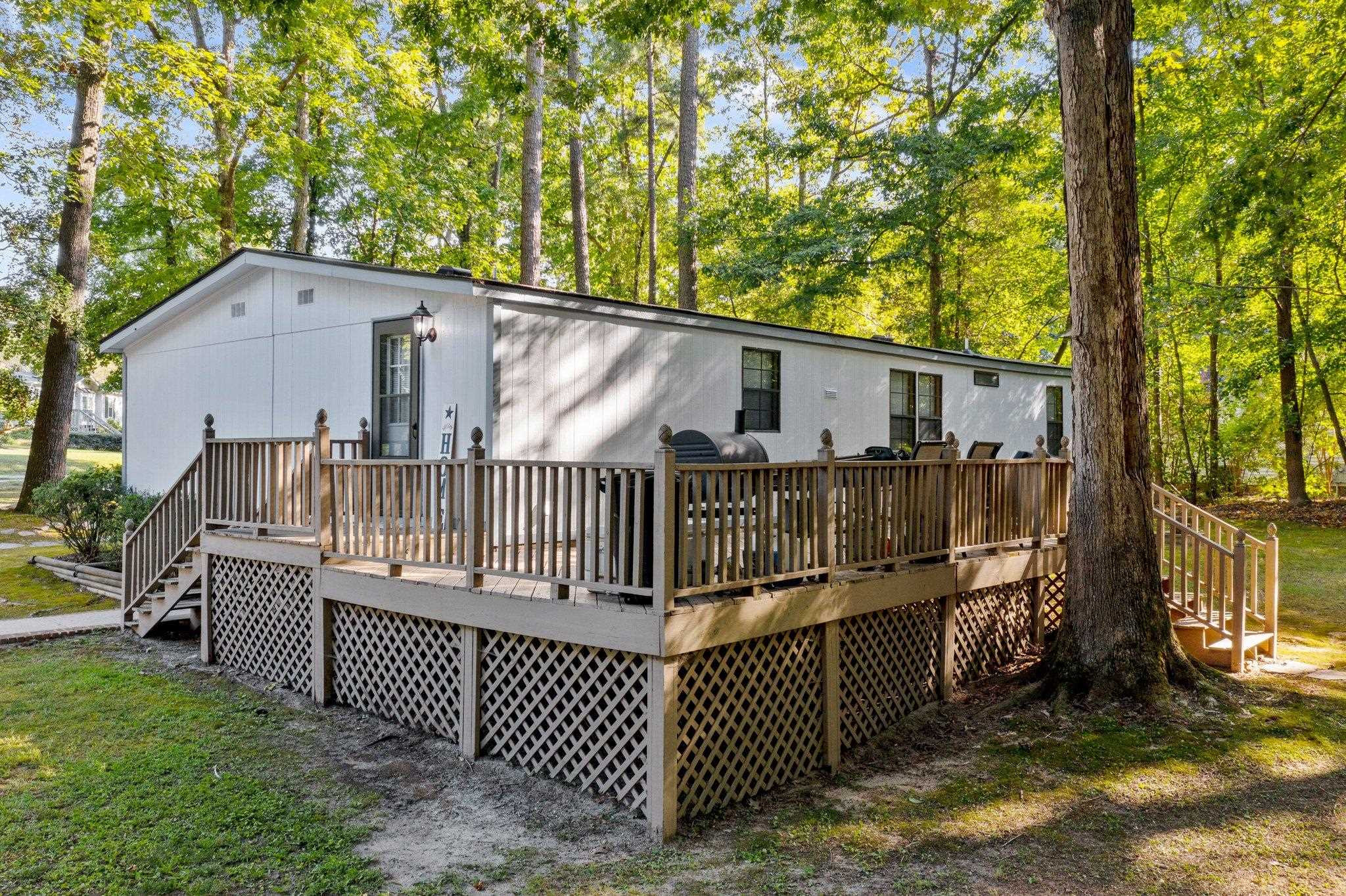 8029 Lockleair Road Zebulon, NC 27597 - Photo 6 of 26 Spacious deck perfect for entertaining and relaxing with views of shady back yard and neighboring pond Deck