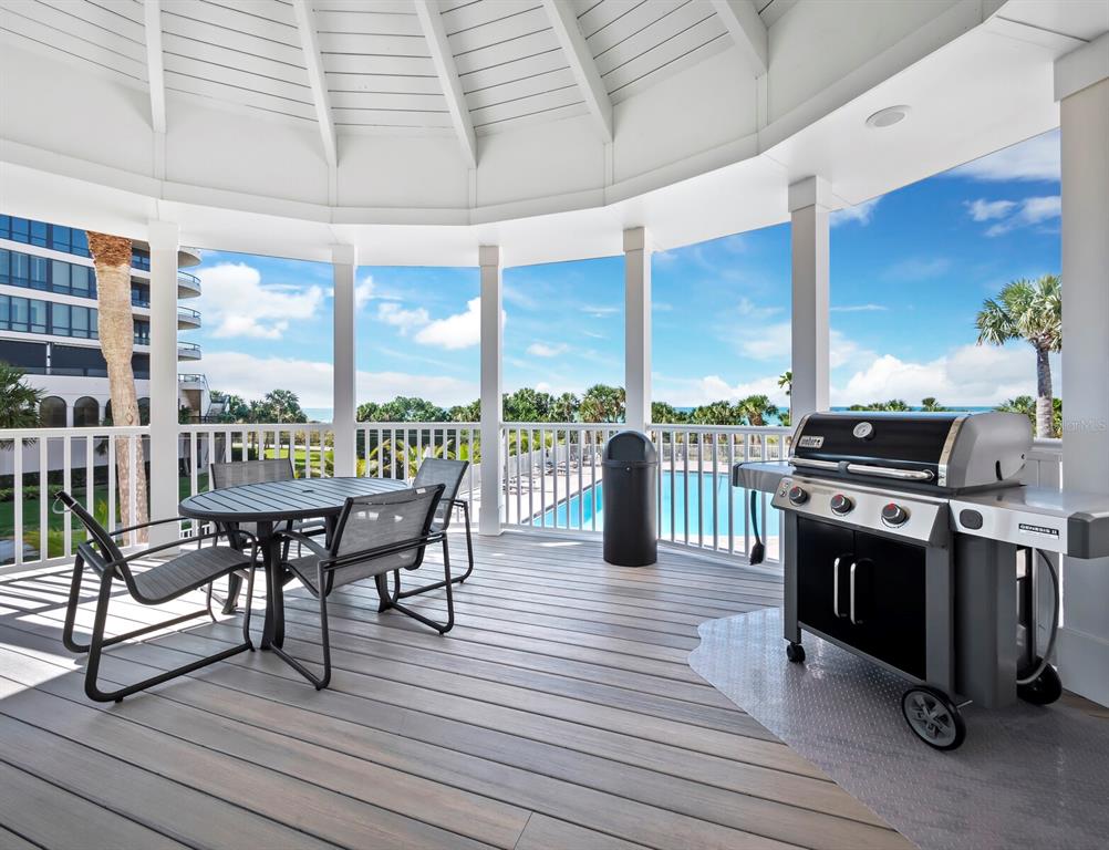 455 Longboat Club Road, Unit 402 Longboat Key, FL 34228 - Photo 34 of 48 a view of a dining room with furniture large windows and wooden floor