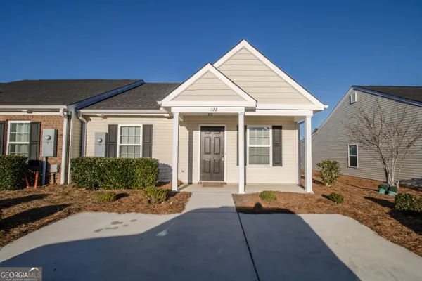 a front view of a house with a yard