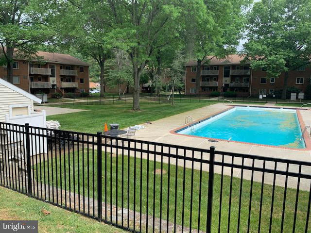 300 Winding Way, Unit 1 Downingtown, PA 19335 - Photo 12 of 13 Serene poolside retreat in lush greenery.
