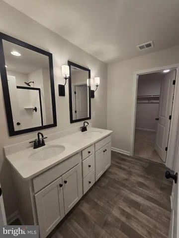 a bathroom with a glass shower door
