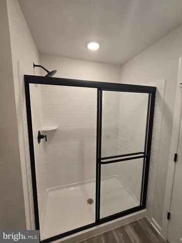 a bathroom with a toilet and a shower