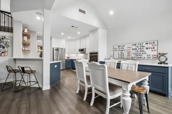 a dining room with furniture and wooden floor