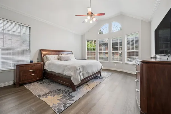 a bedroom with a bed dresser and window