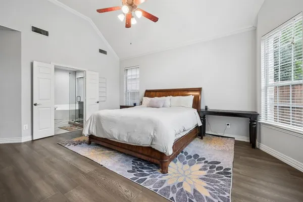 a bedroom with a bed and a chandelier