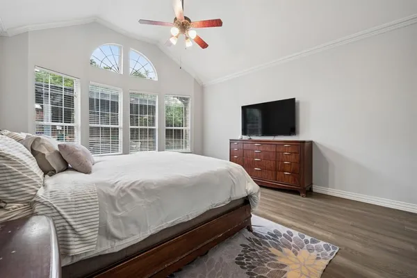 a bedroom with a bed and a flat screen tv