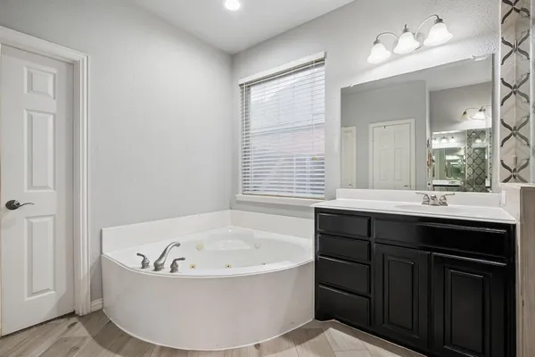 a bathroom with a bathtub and a sink