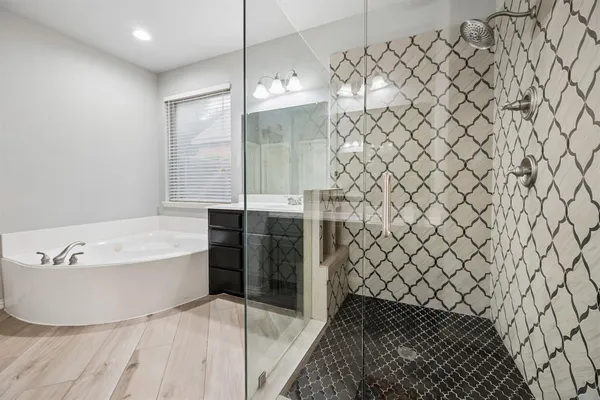 a bathroom with a bathtub and shower
