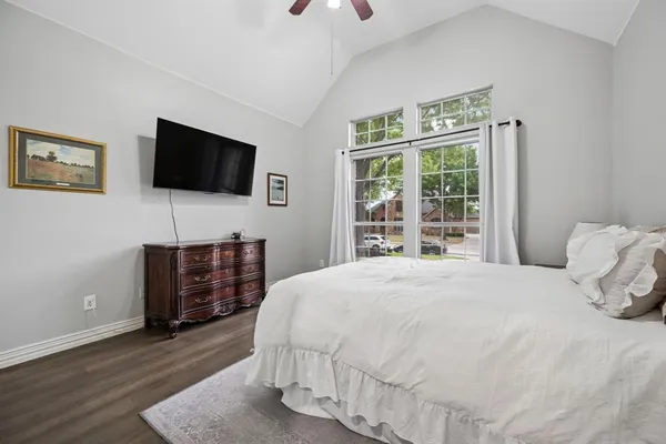 a bedroom with a bed and a flat screen tv