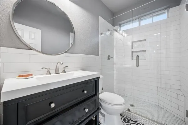 a bathroom with a sink toilet and shower