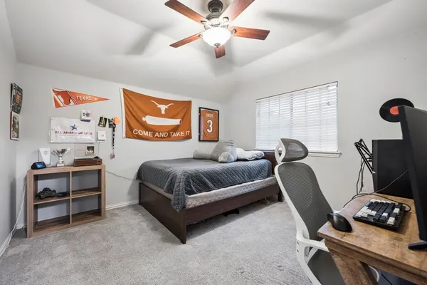 a bedroom with a bed and a chair