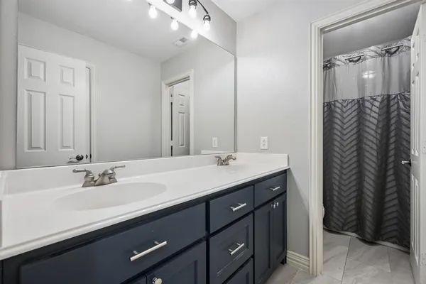 a bathroom with a sink double vanity and a mirror