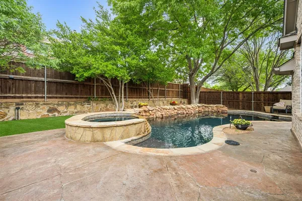 a view of a backyard with swimming pool