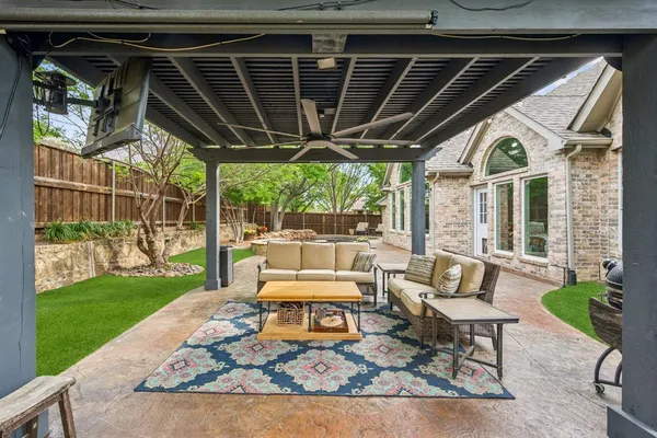 a view of a chairs and table in patio with a small yard