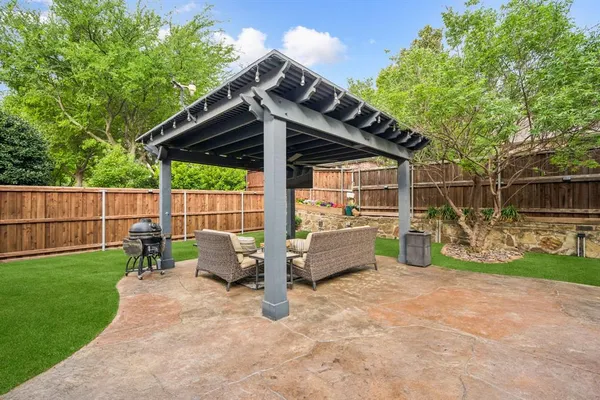 a view of backyard with sitting area