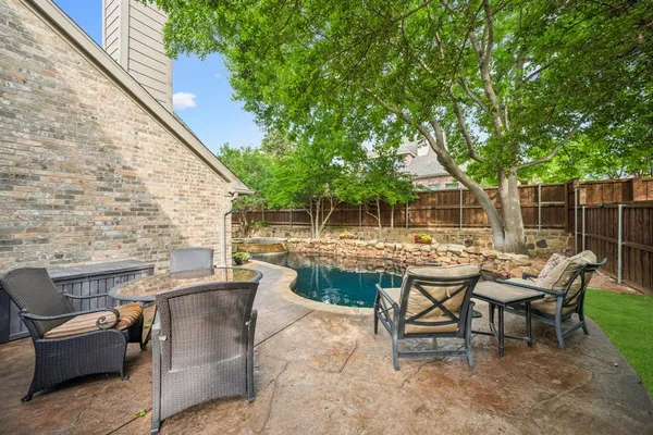 a view of backyard with outdoor seating a patio and plants
