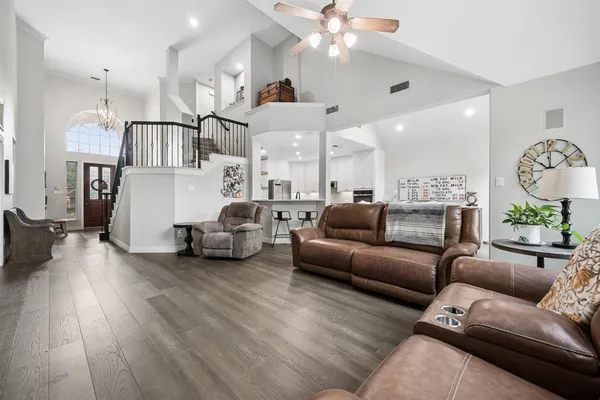a living room with furniture and kitchen view