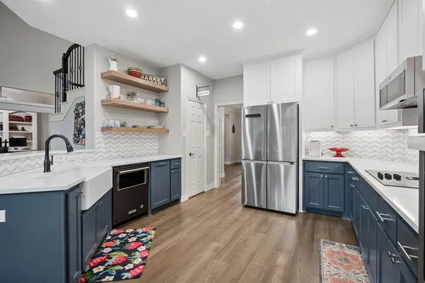 a kitchen with granite countertop a refrigerator stove and sink